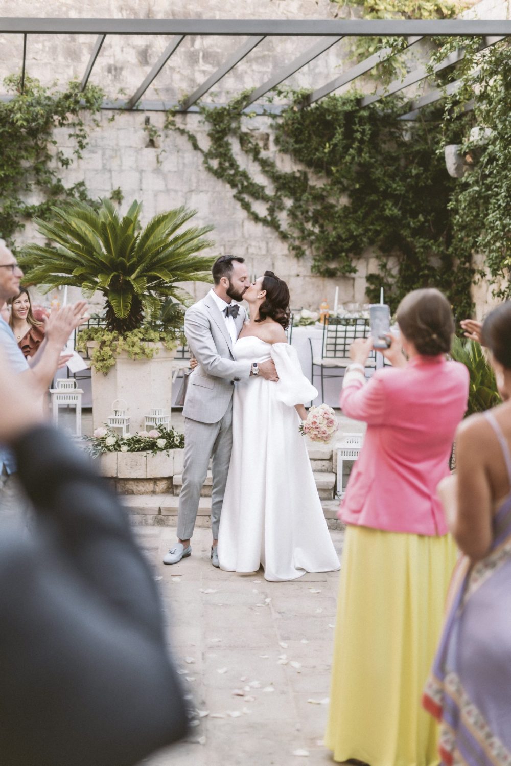 Bride and groom kissing at their wedding reception in San Giorgio Hotel in Vis