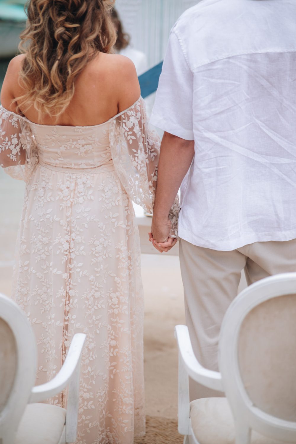 Bride and groom holding hands during their wedding ceremony at Levan Island in Istria