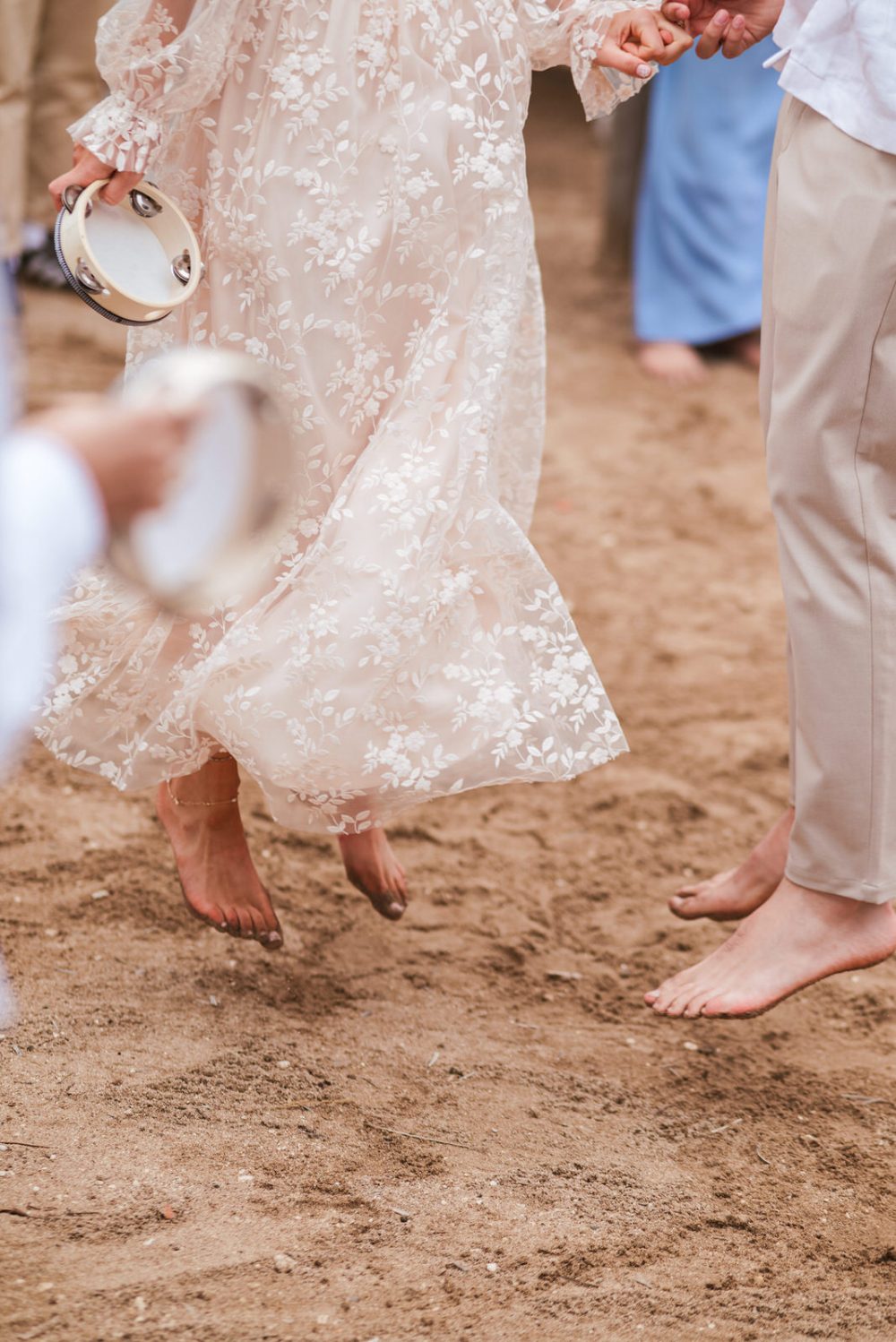 Bride and groom dancing barefoot in the sand at Levan Island Istria