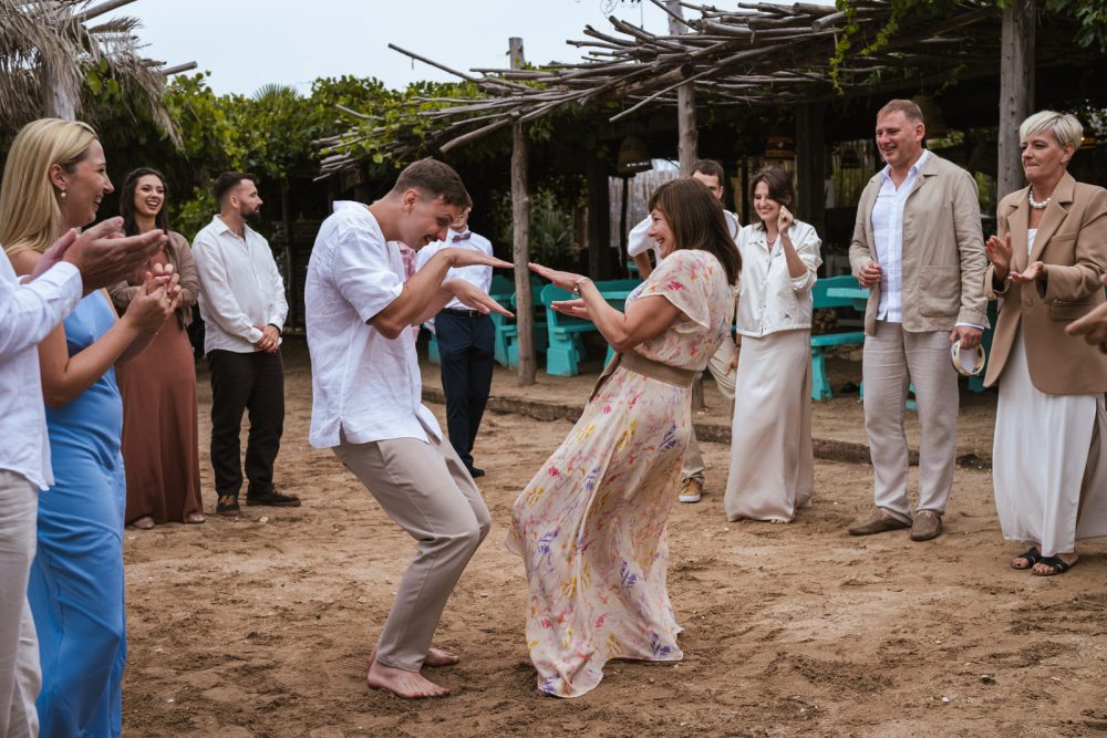 Bride and groom dancing barefoot in the sand at Levan Island Istria