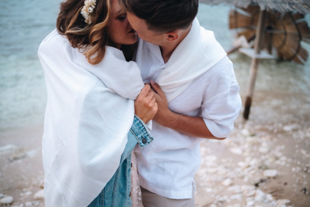 Newlyweds kissing on the beach on Levan Island in Istria