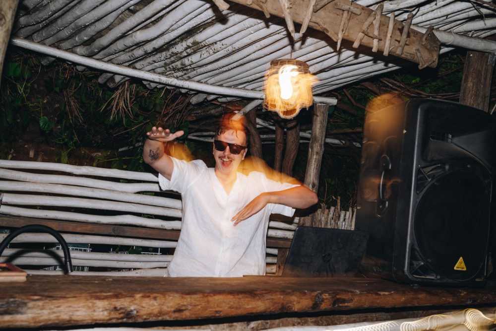 Groom playing DJ at his wedding on Levan Island in Istria