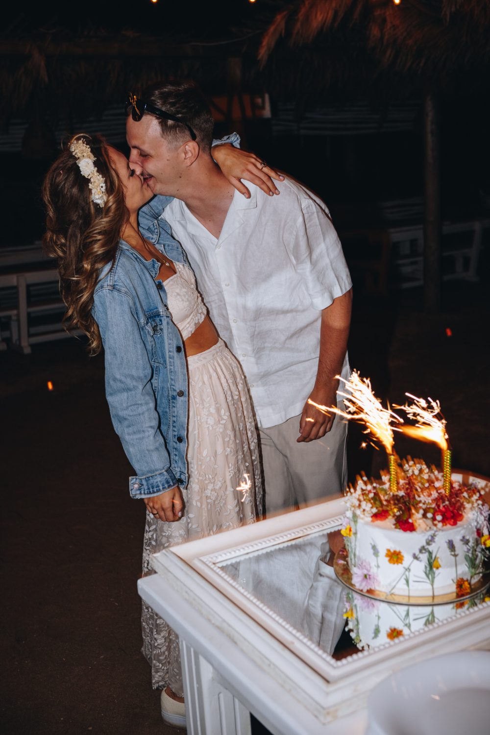 Bride and groom kissing before cake-cutting on Levan Island, Istria