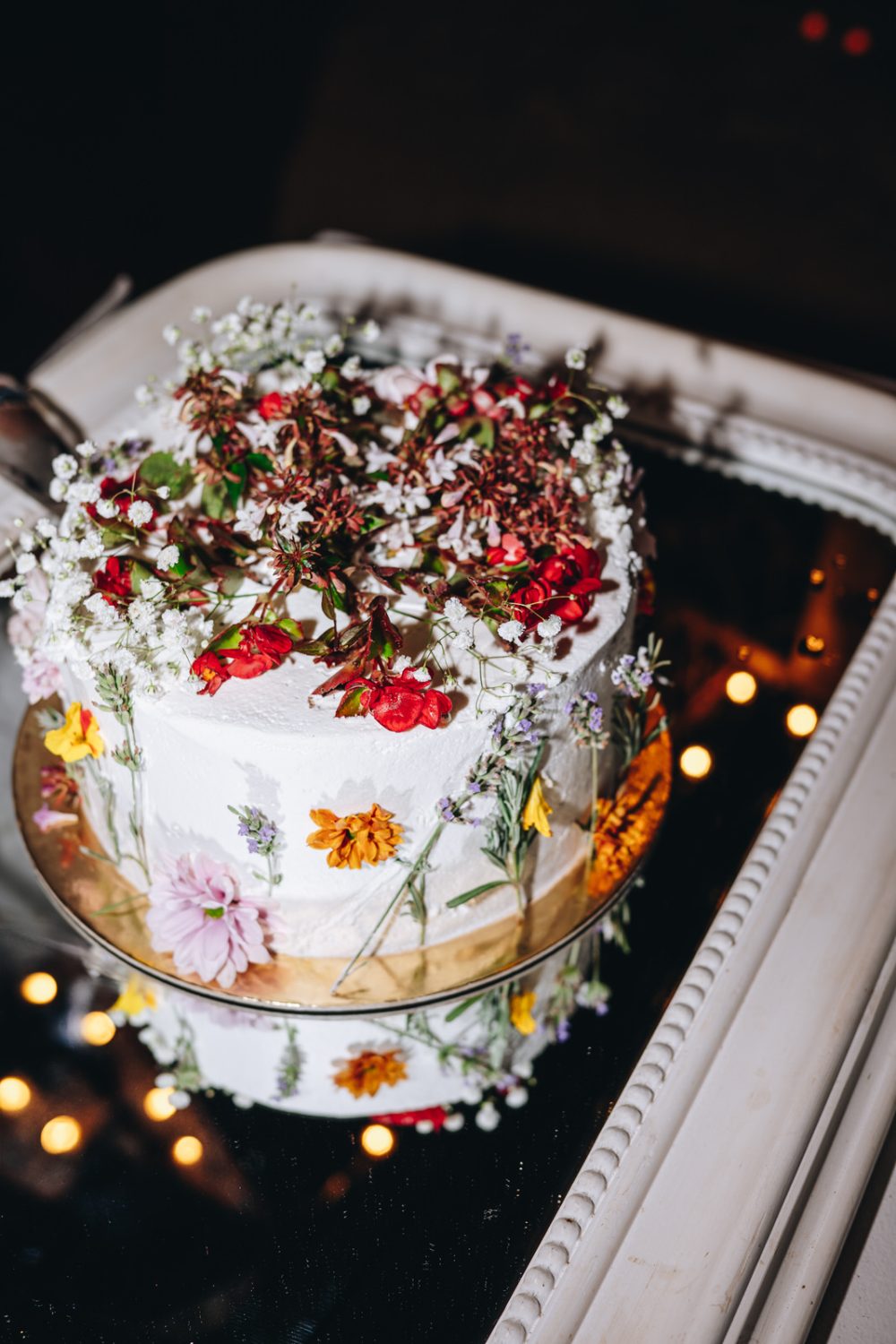 Colourful wedding cake decorated with real flowers