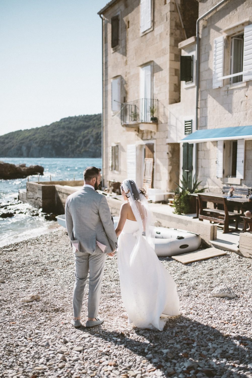 Newlyweds posing on the beach in Komiza Vis