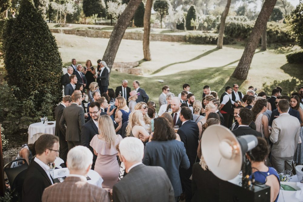 Guests mingling and enjoying cocktails at an elegant outdoor reception at Martinis Marchi Castle, Croatia