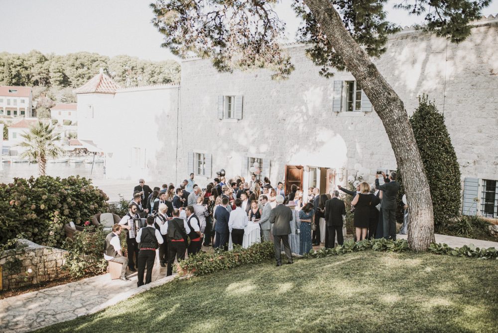 Guests enjoying cocktails at an elegant outdoor reception at Martinis Marchi Castle, Croatia