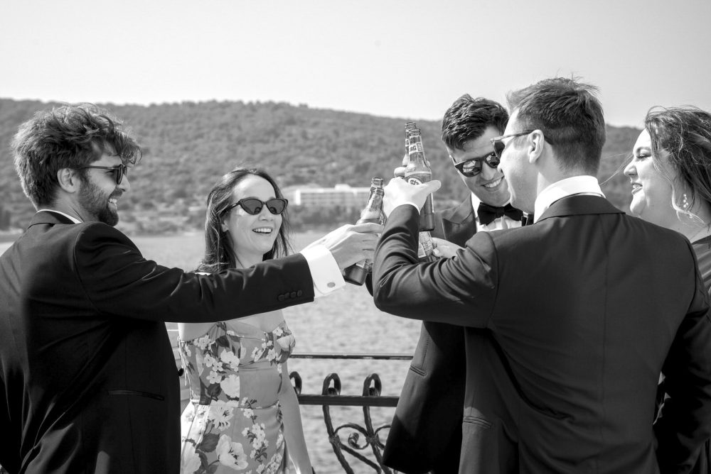 Wedding guests rise a toast in Vis