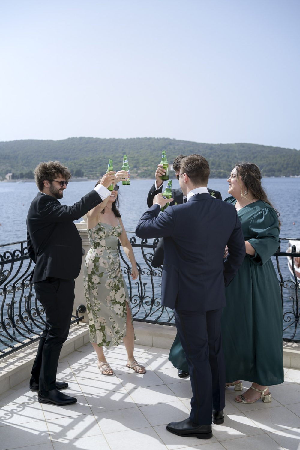 Wedding guests rise a toast in Vis