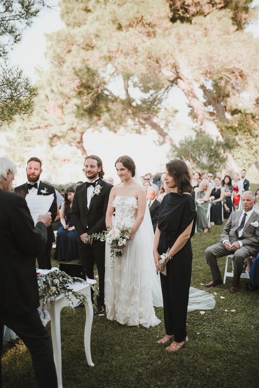 Bride and groom exchanging vows during a black-tie wedding ceremony at Martinis Marchi