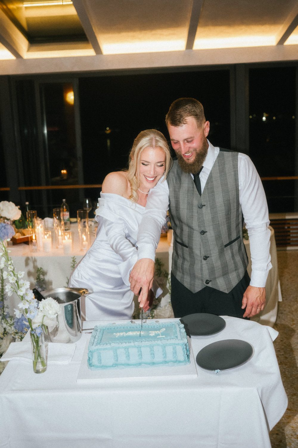 bride and groom cutting wedding cake